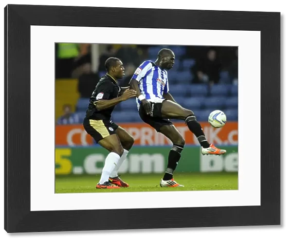 Owls v Leicester... Mamady Sidibe holds off Wes Morgan