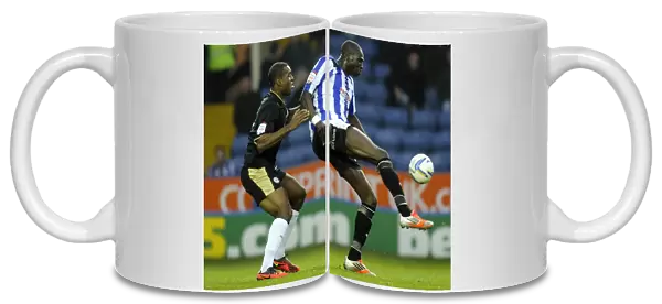 Owls v Leicester... Mamady Sidibe holds off Wes Morgan