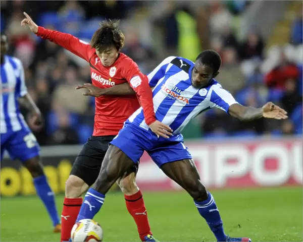 Cardiff City v Sheffield Wednesday... Owls Michail Antonio holds off Citys Kim Bo-Kyung