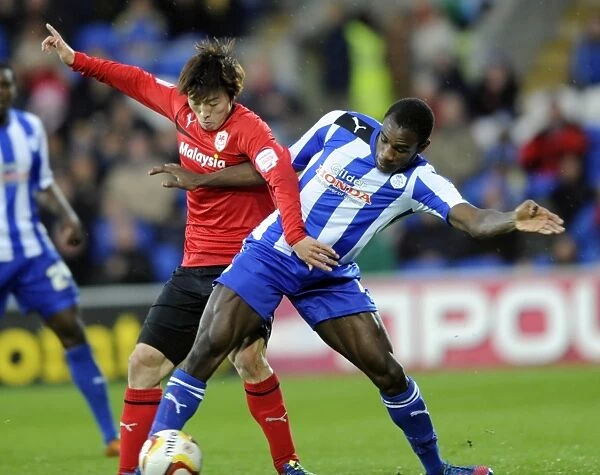 Cardiff City v Sheffield Wednesday... Owls Michail Antonio holds off Citys Kim Bo-Kyung