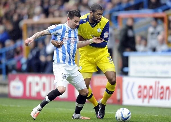 Huddersfield Town v Sheffield Wednesday... Owls Reda Johnson with Towns Adam Hammill