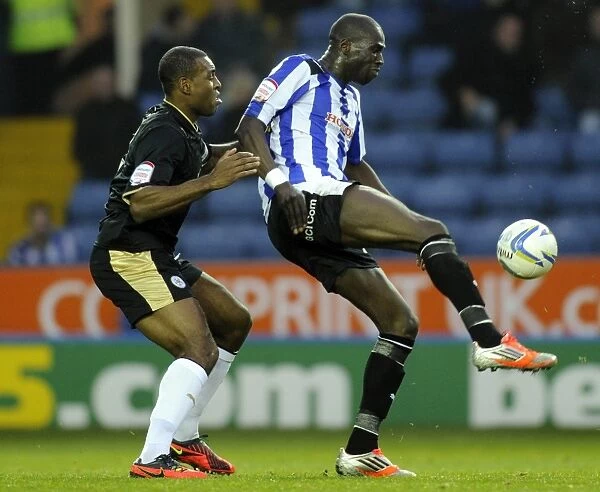 Owls v Leicester.....Mamady Sidibe holds off Wes Morgan
