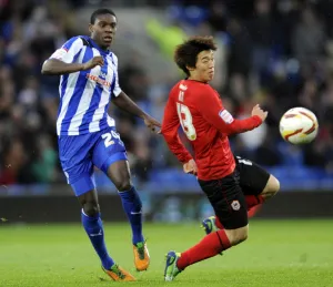 Cardiff City v Sheffield Wednesday... Owls Jeremy Helan beats Citys Kim Bo-Kyung