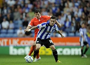 Sheffield Wednesday v Millwall... Rhys McCabe holkds off Darius Henderson