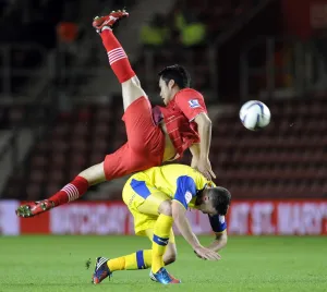 Southampton v Sheffield Wednesday... Gary Madine feels the challenge of Saints Maya Yoshida